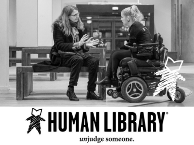 Woman in wheelchair talking to woman on bench - text: Human Library unjudge someone.